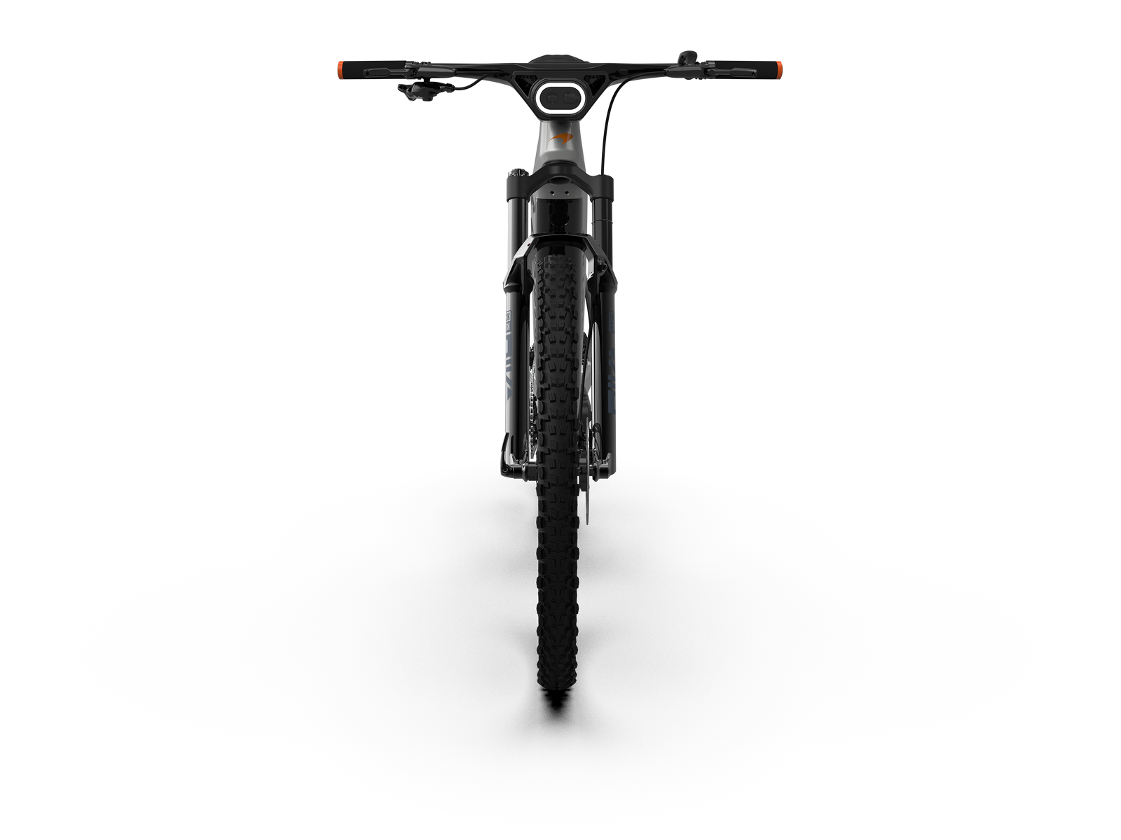 The McLaren Sport hardtail electric mountain bike with 29-inch wheels and SRAM Eagle GX mechanical drivetrain shot from the front with the integrated headlamp illuminated.